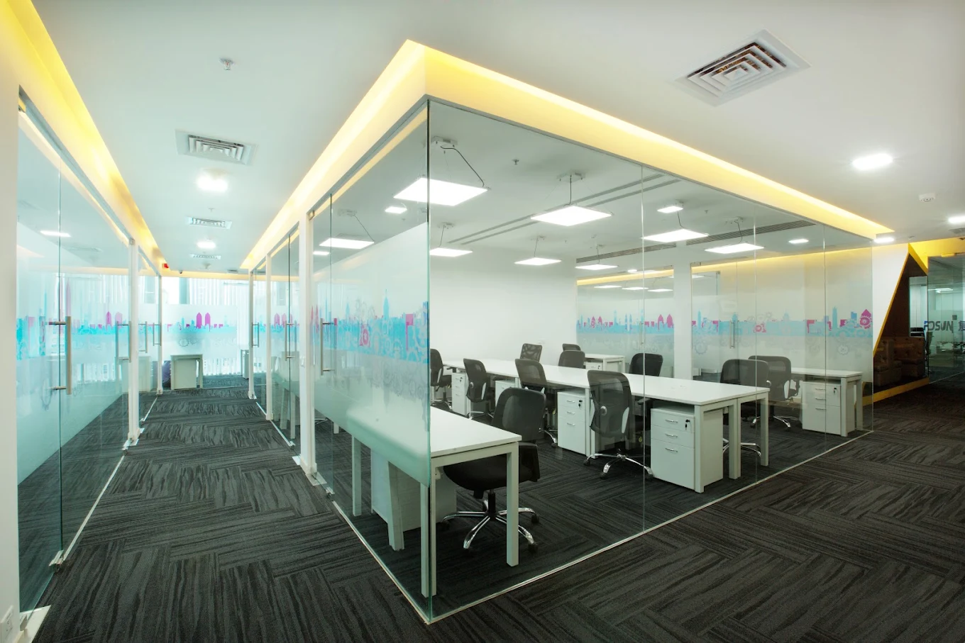 Modern office interior with glass partitions and workstations