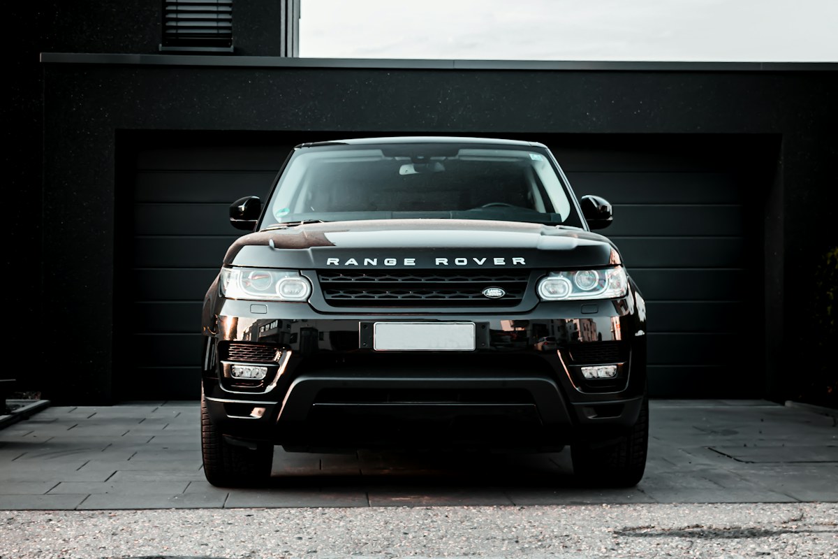 A front view of an electric vehicle displayed in a dark studio setting.
